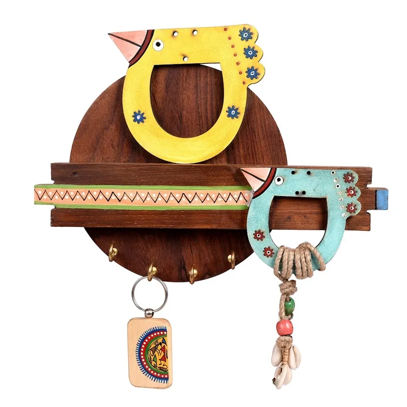 Close-up of a brown wooden key holder with yellow and turquoise bird designs