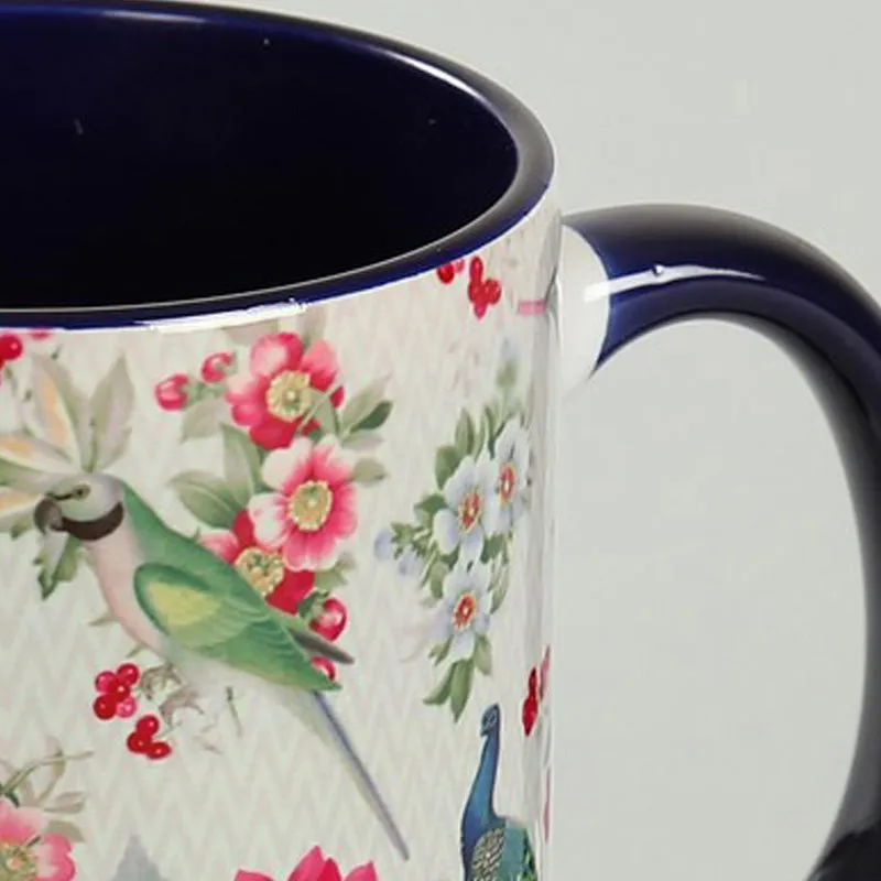 Close-up of the glossy handle and bird-and-flower mug design