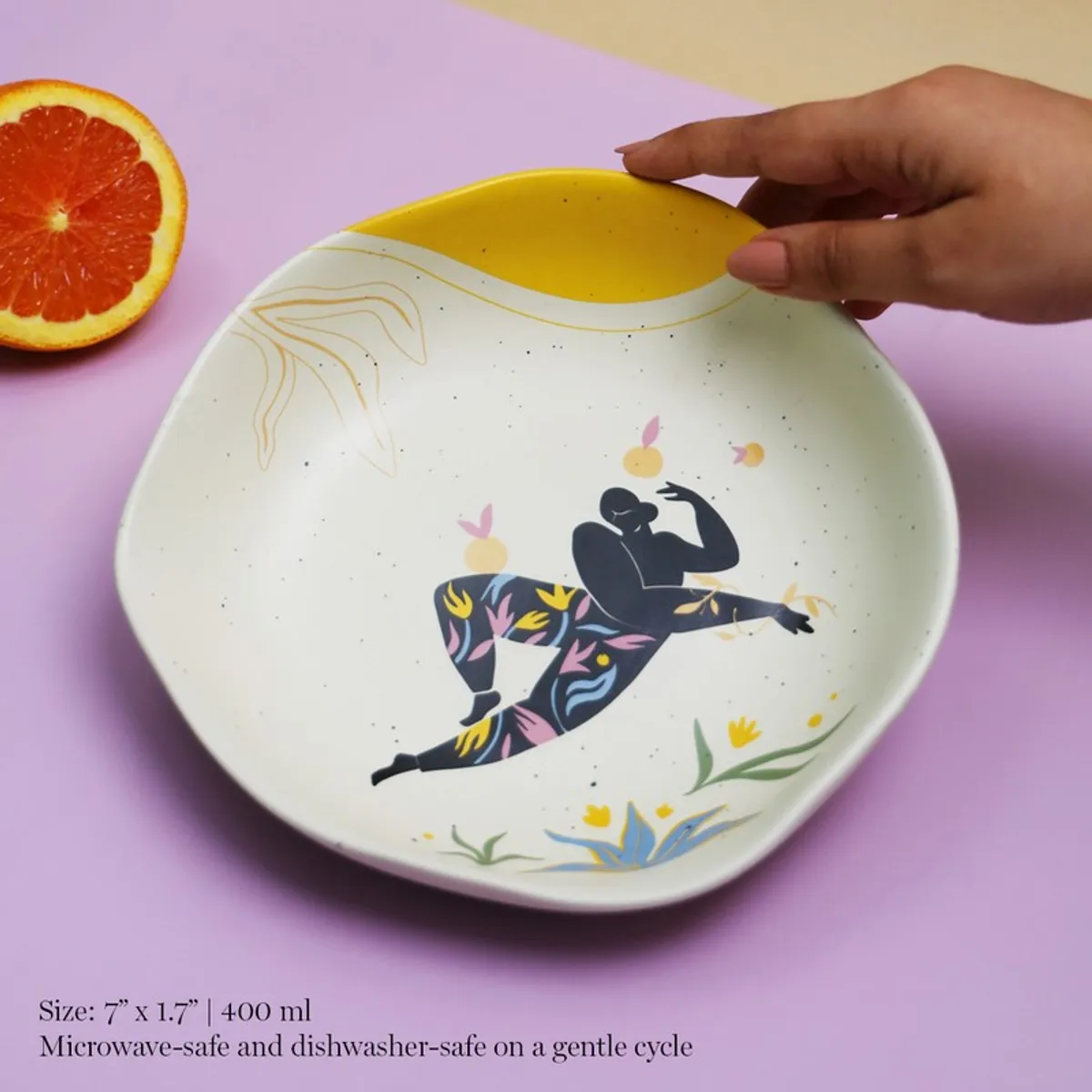 Close view of illustrated porcelain pasta plate with yellow rim accent