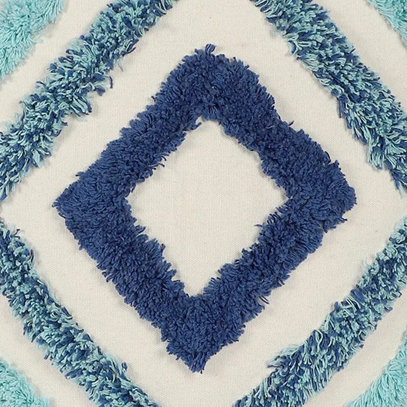Close-up view of the raised tufted geometric texture in blue tones