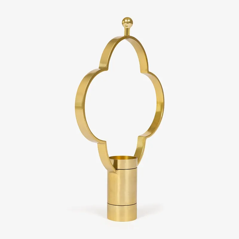 Angled view of gold candle holder with Moorish arch silhouette