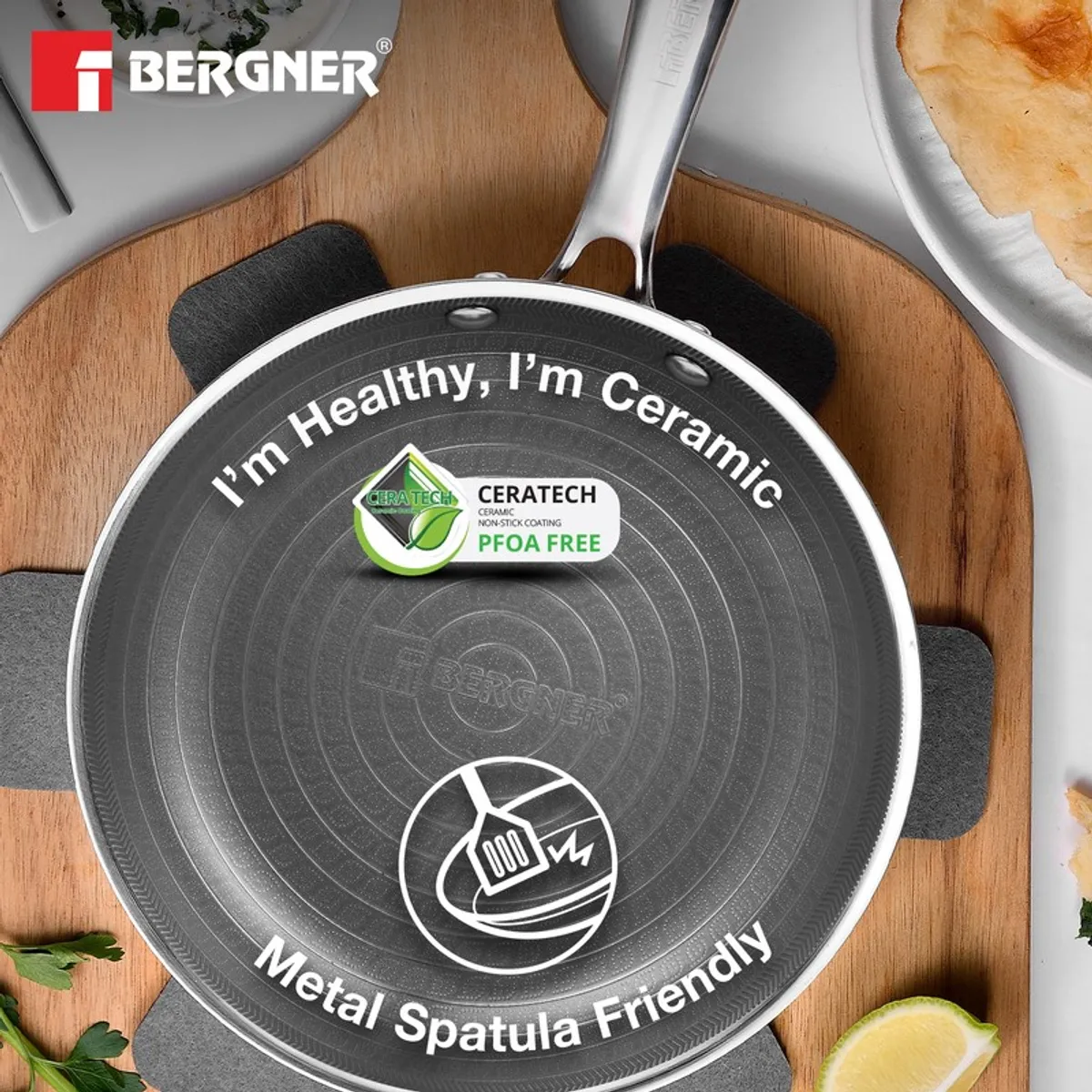 Top view of silver frying pan with vegetables and ceramic coating graphic