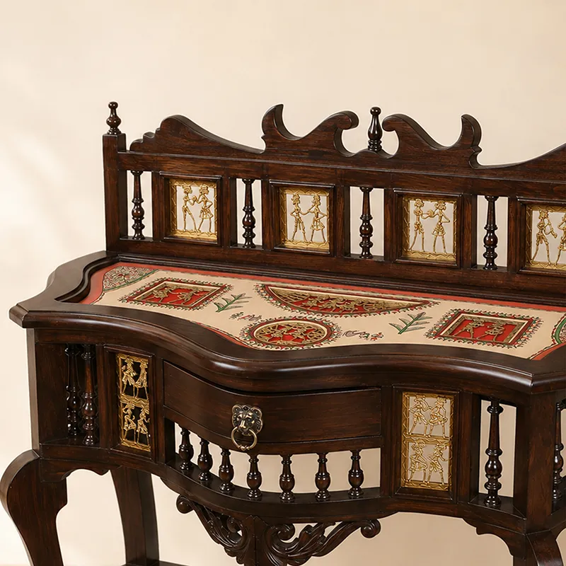 Close-up of ornate teak wood console table with drawer and decorative panels