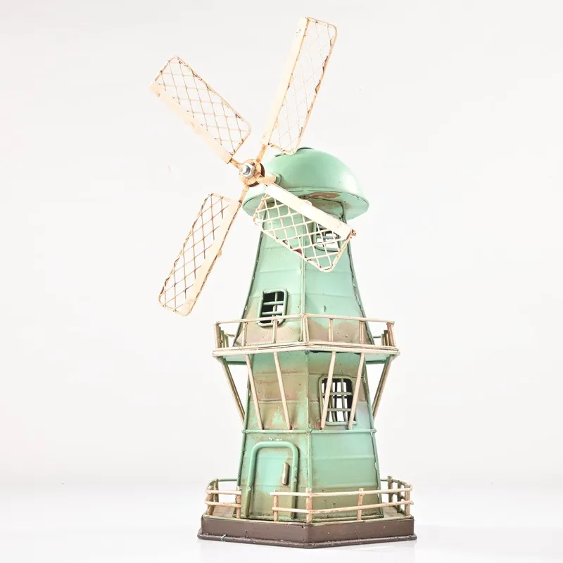 Front view of a blue iron windmill showpiece on a white background