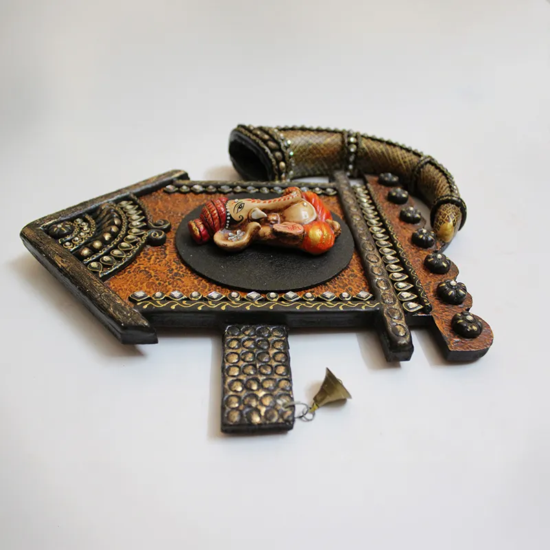 Close view of the Ganesha wall accent showing raised handcrafted detailing