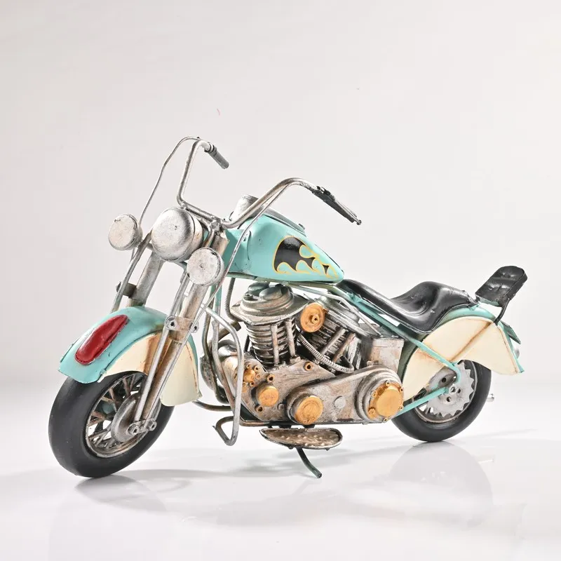 Blue and silver vintage motorcycle showpiece on a white background