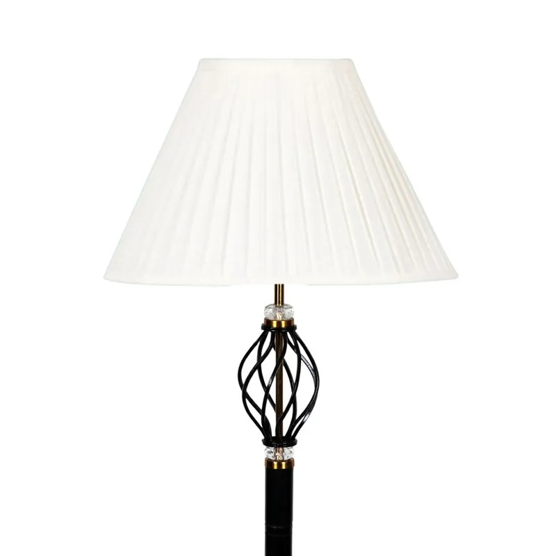 Close-up of white pleated shade and decorative black lamp stem