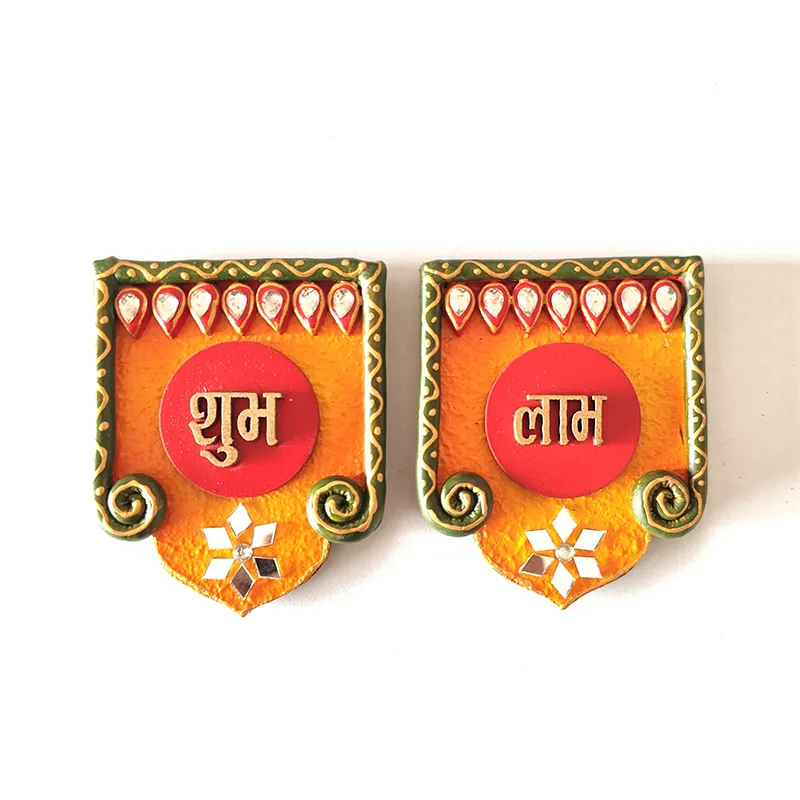 Front view of two handcrafted Shubh Labh wall accents in orange, red and green