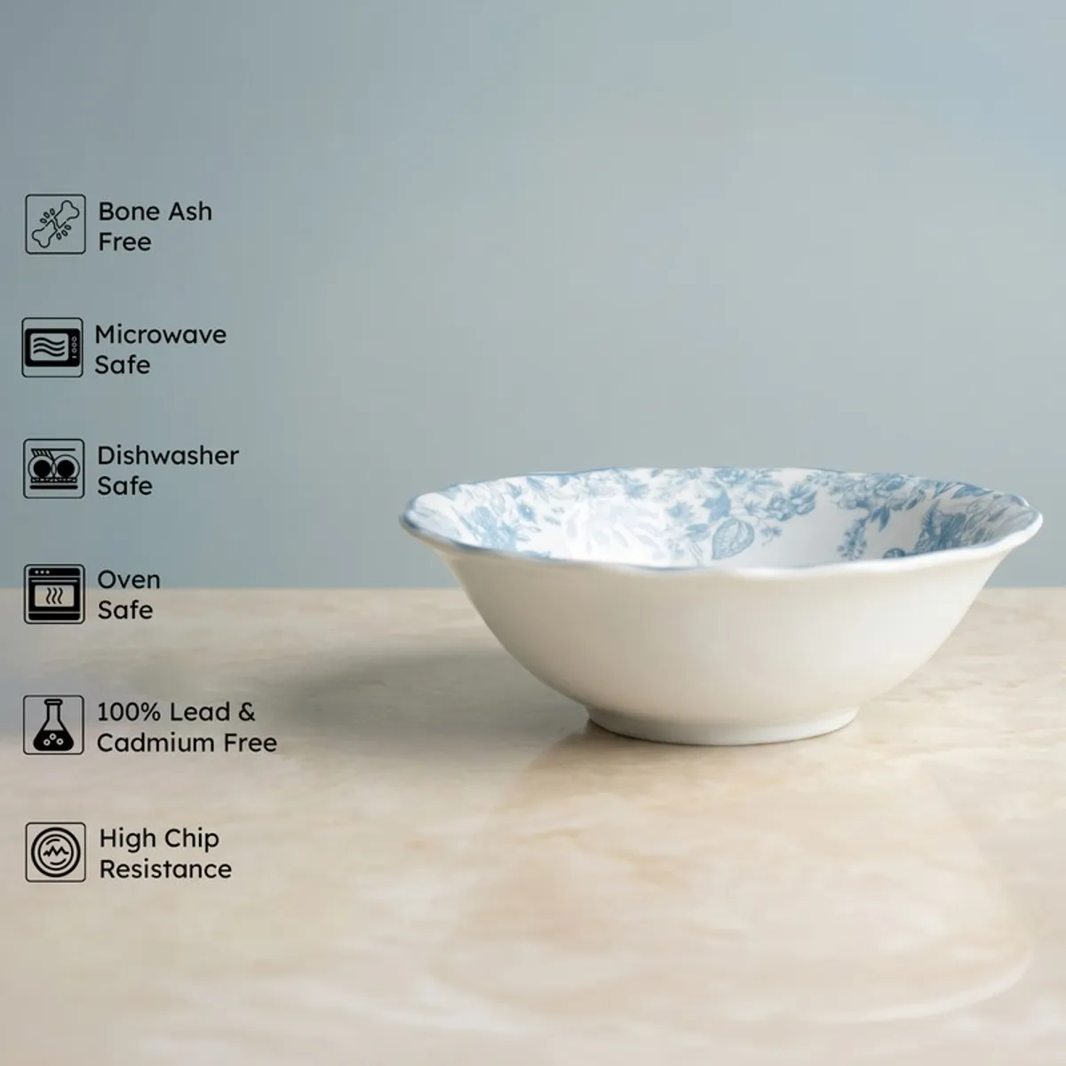 Blue and white floral serving bowl on a marble surface