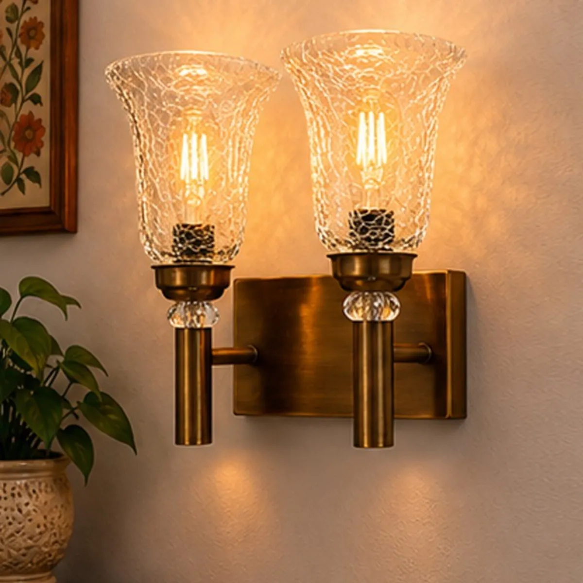 Angled view of a gold twin wall lamp with textured glass shades