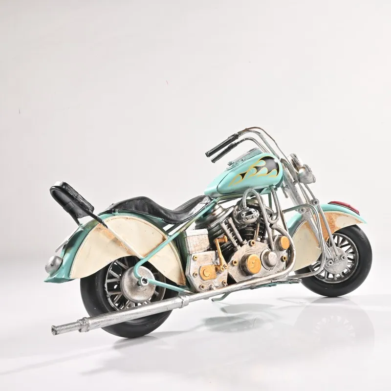 Rear side view of blue vintage motorcycle showpiece on a white background