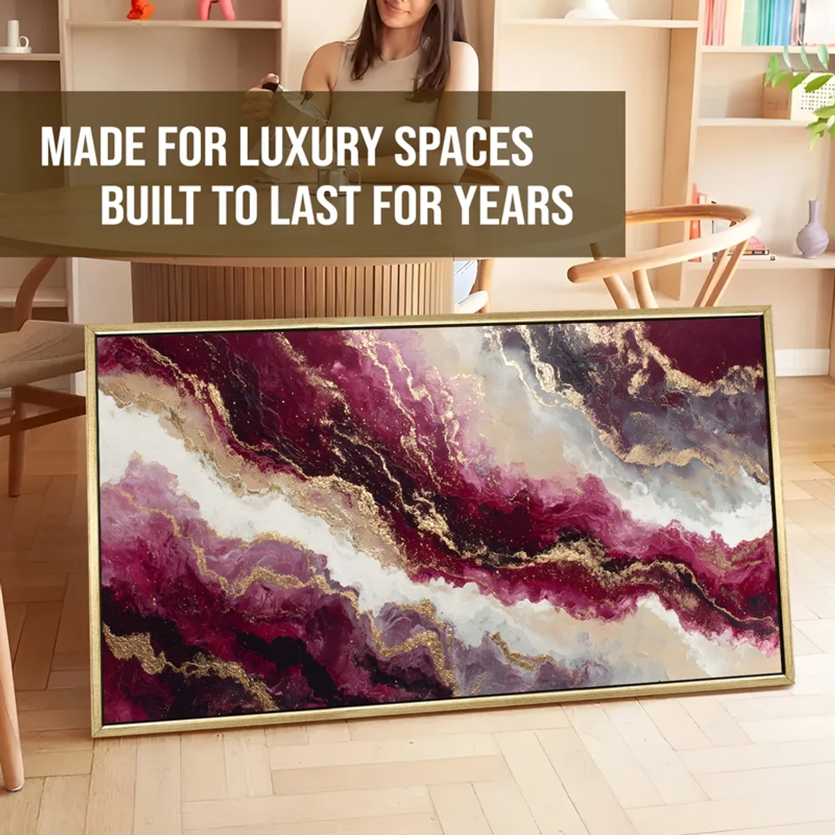 Large framed abstract painting in purple, white and gold leaning indoors