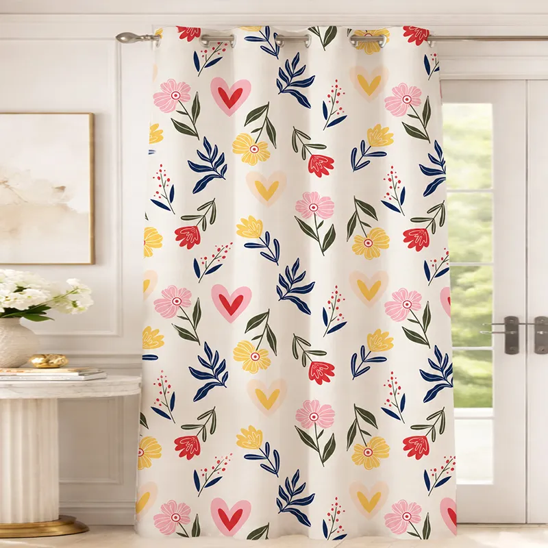 Multicolour floral and heart print curtain hanging across a glass door.