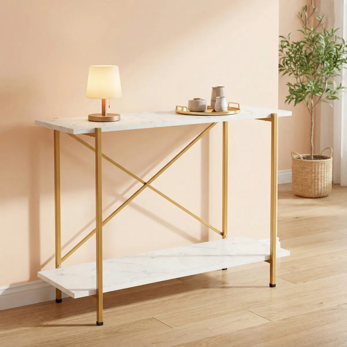 Two-tier white and gold console table with a lamp and tray