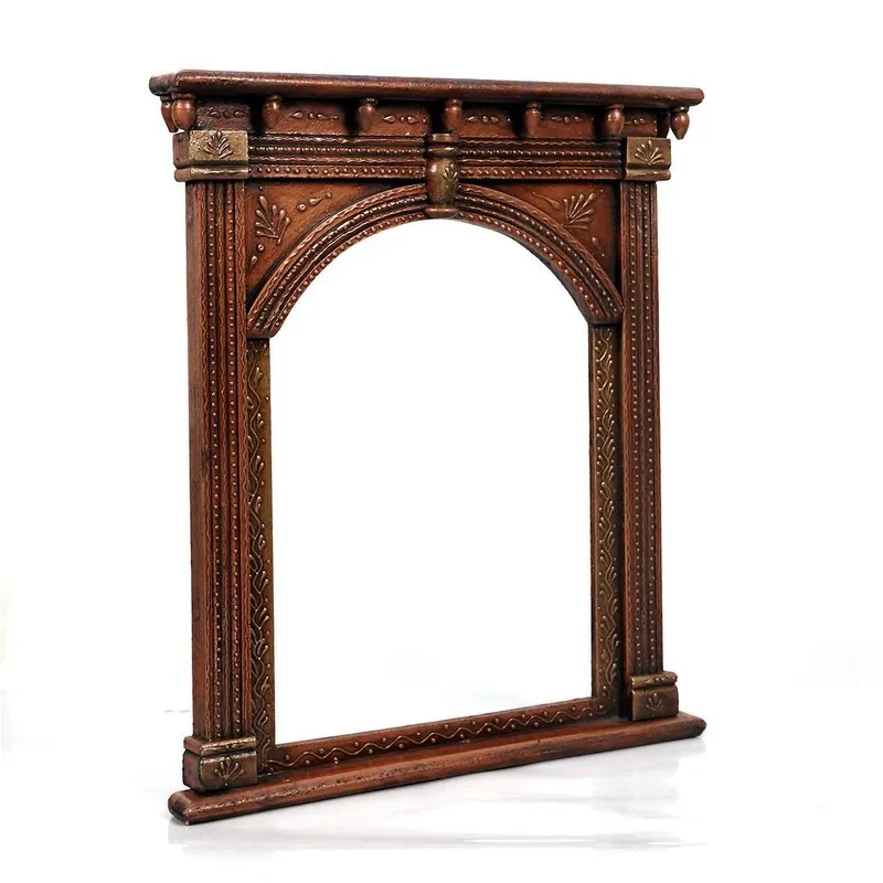 Angled view of carved archway wood wall accent with ornate detailing