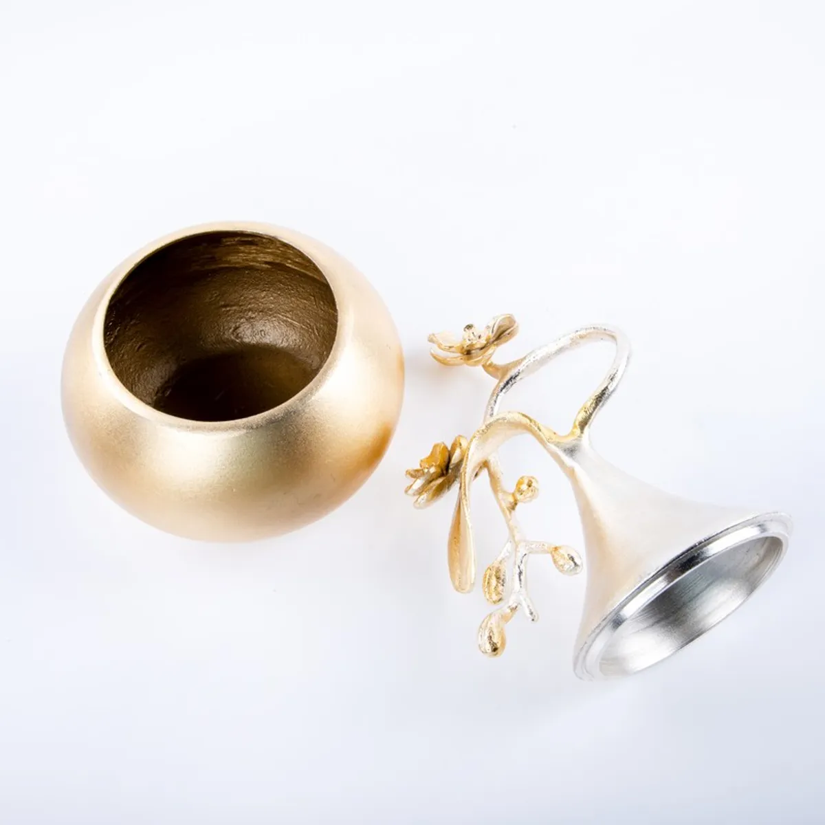 Top view of the open gold bowl and detached silver ornamental cover