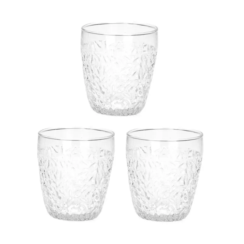 Three clear textured drinking glasses on a white background