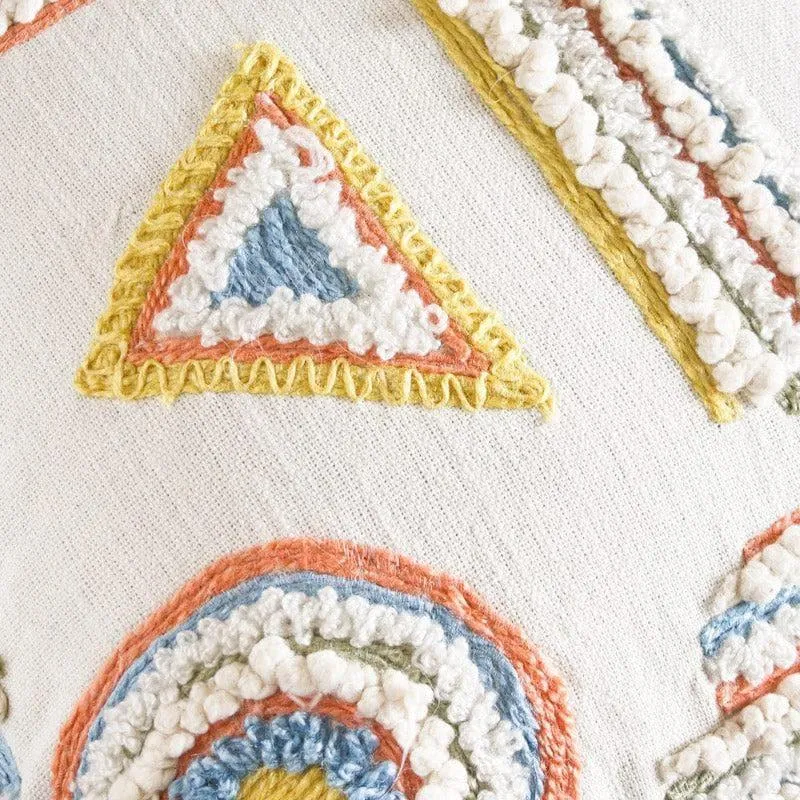 Close-up of multicolour tufted geometric embroidery on the cushion cover