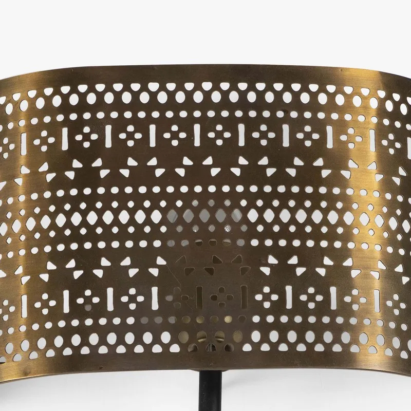 Close-up of the gold perforated metal shade with geometric cutwork