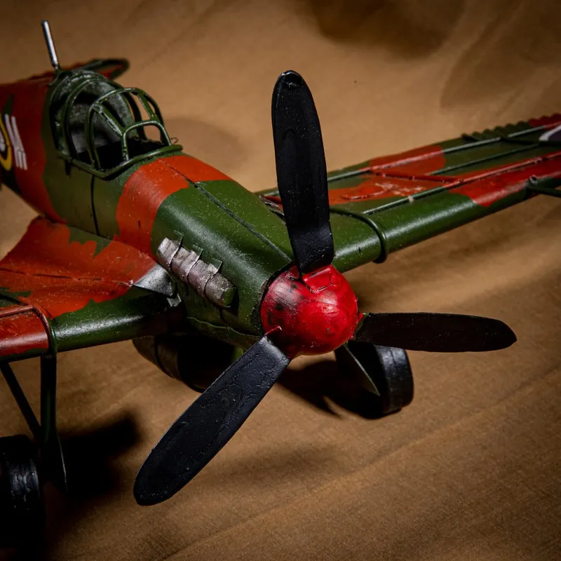 Close-up of the aeroplane showpiece front with black propeller and cockpit detail
