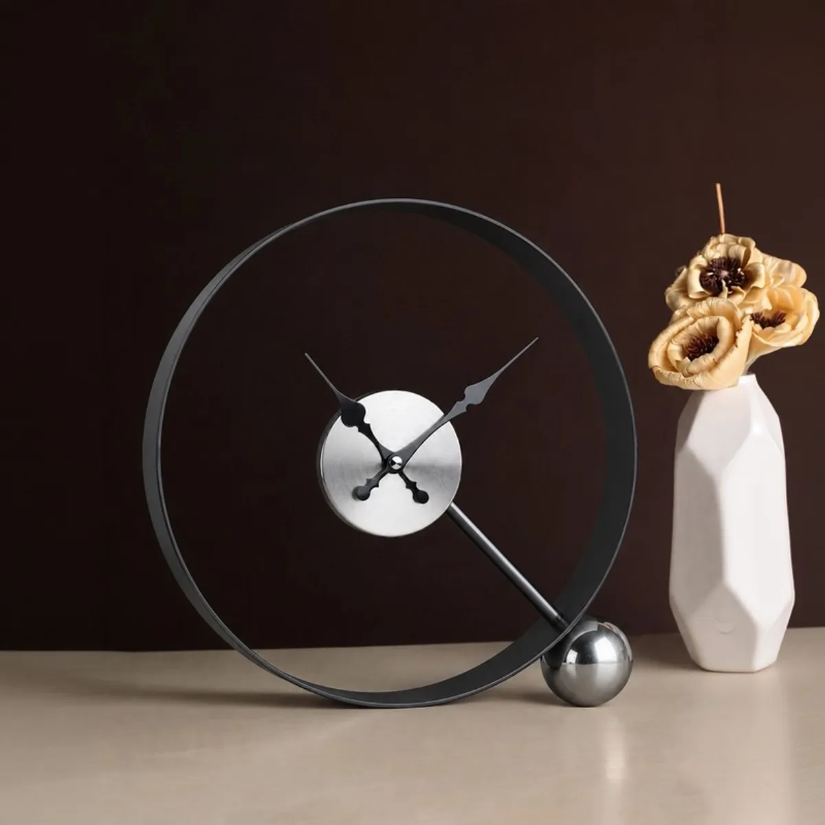 Open round table clock with silver centre and metallic base detail