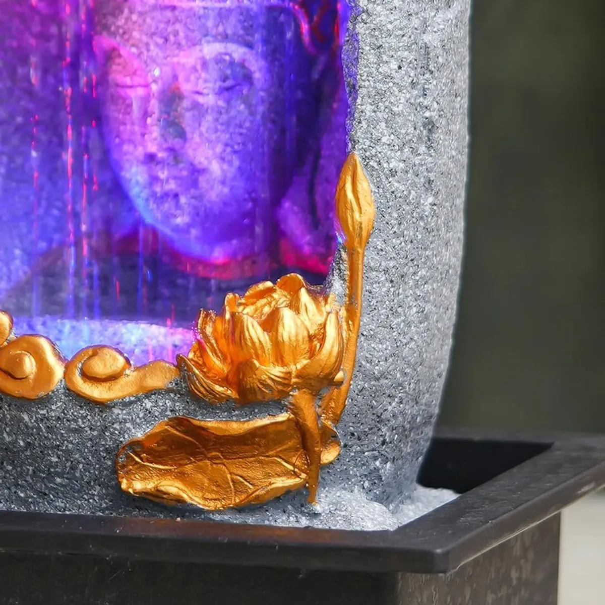Close-up of gold lotus detail on the fountain