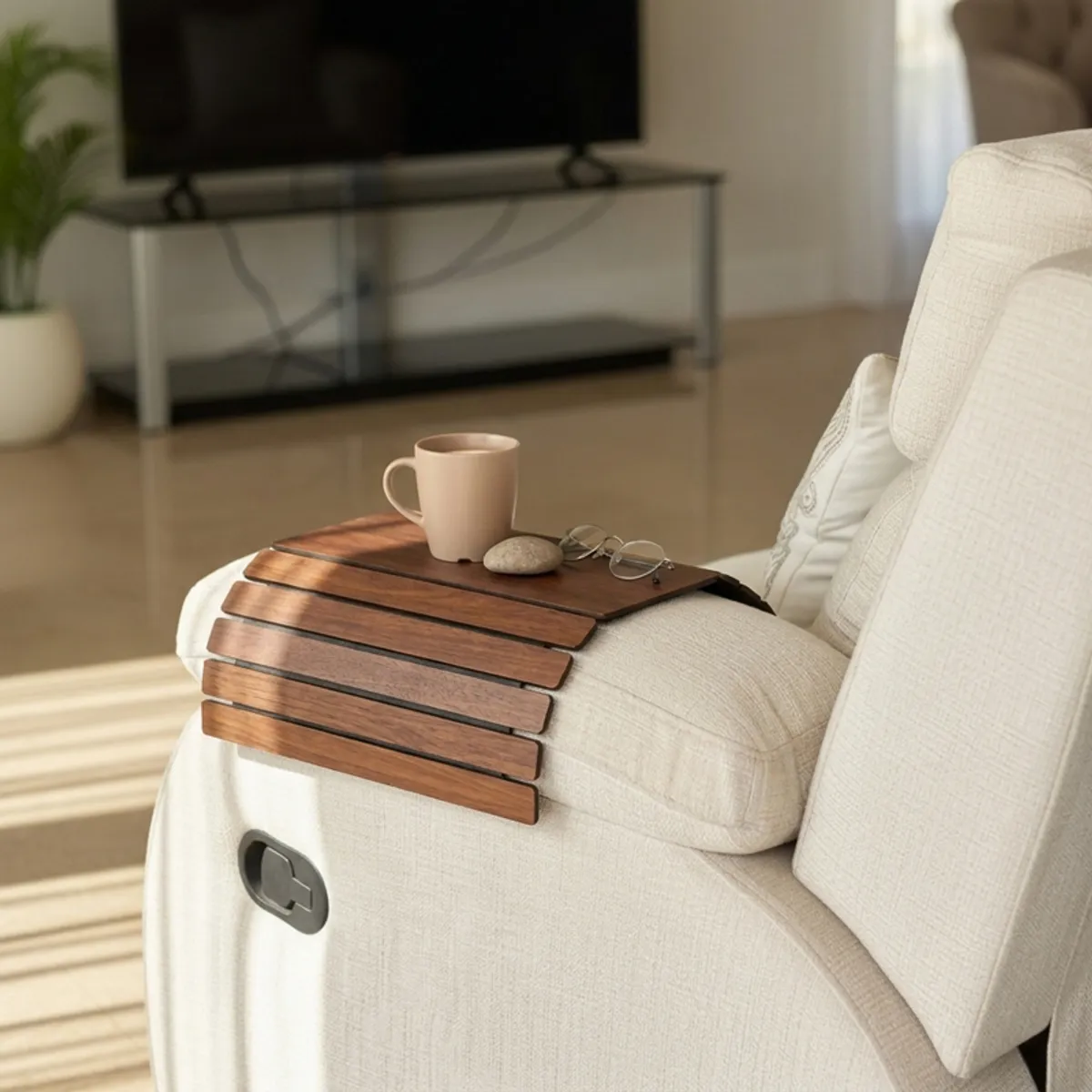 Brown sofa armrest tray with a mug on a cream sofa arm