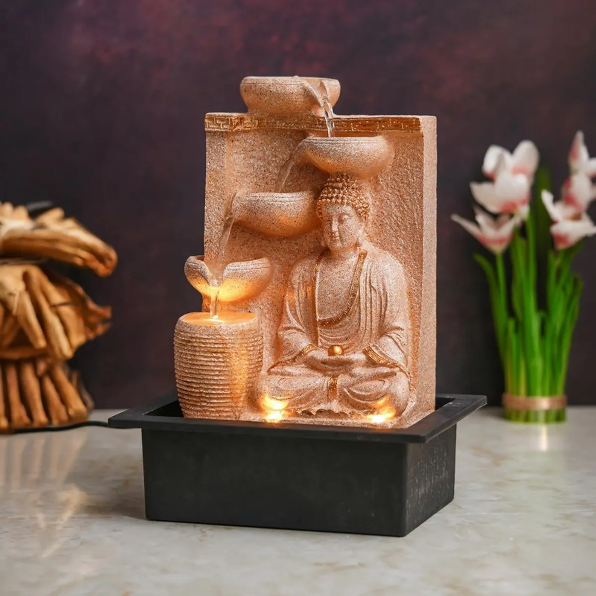 Angled view of ivory Buddha tabletop fountain with warm LED lights