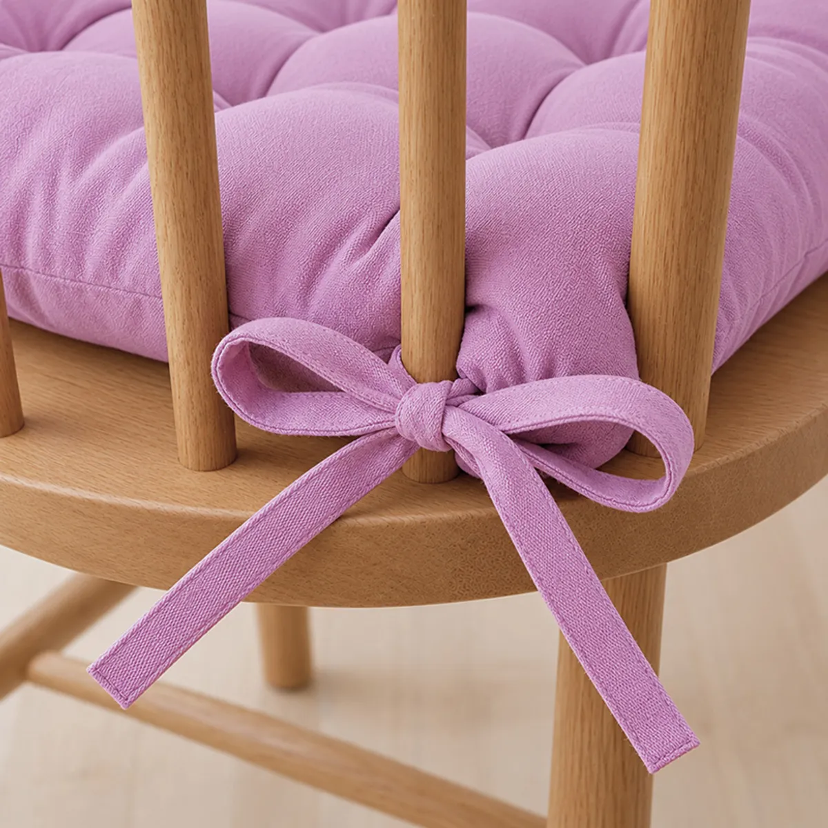 Close-up of lilac purple tie-up fastened to a wooden chair
