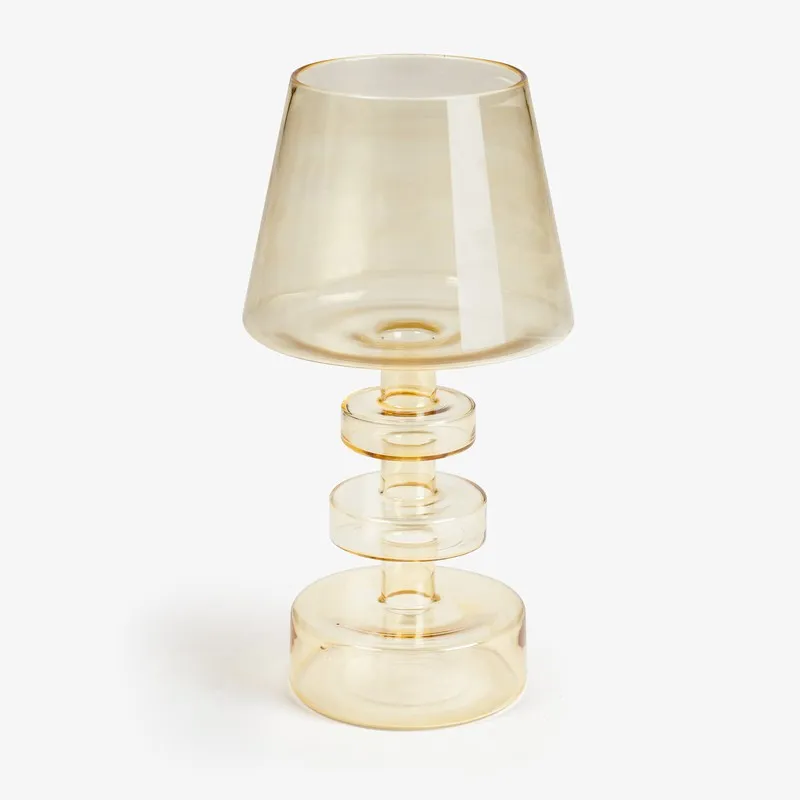 Amber glass candle holder with tapered shade-like top and cylindrical base