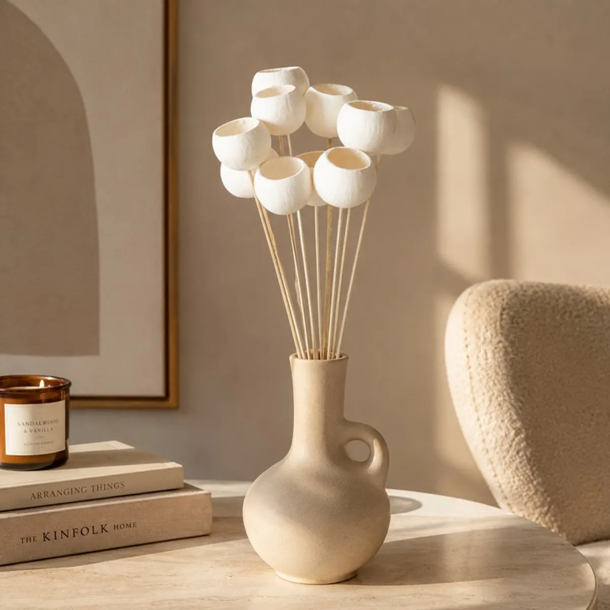 White dried bell cup stems displayed in a neutral vase on a living room table