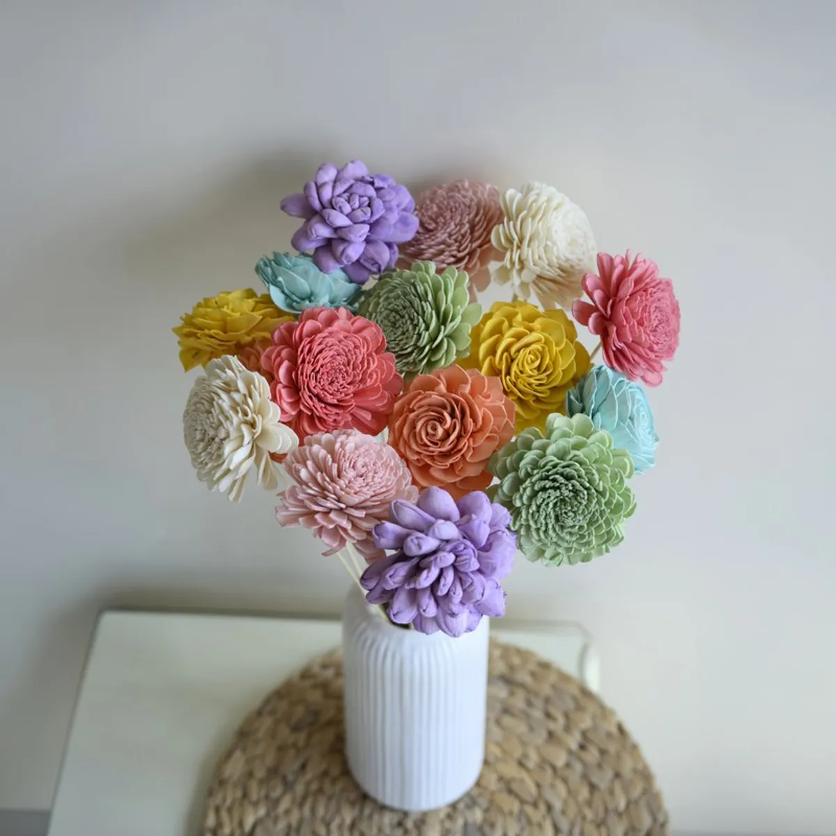 Top view of layered multicolour sola wood flowers in a white vase