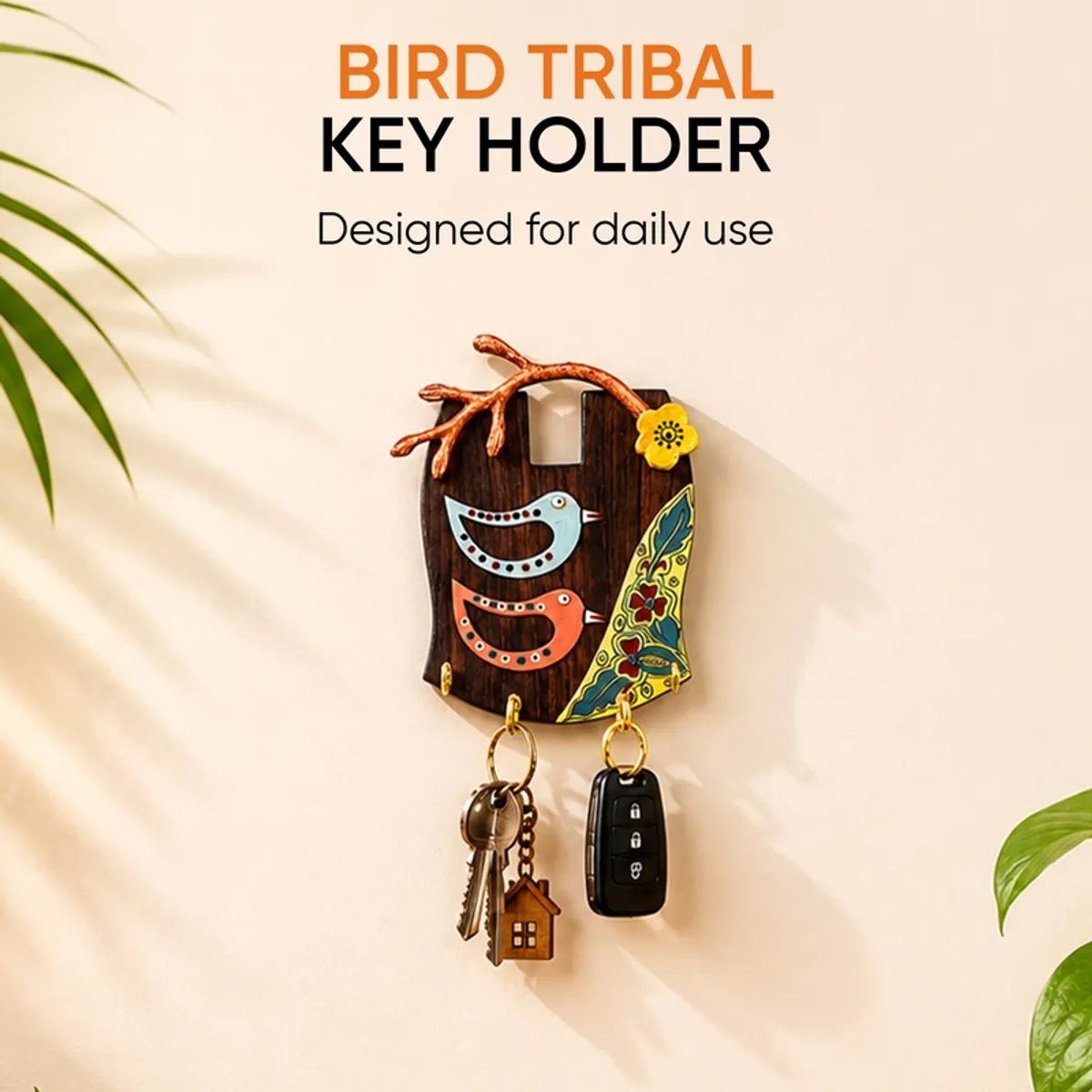 Bird-themed wooden key holder styled on a bright wall