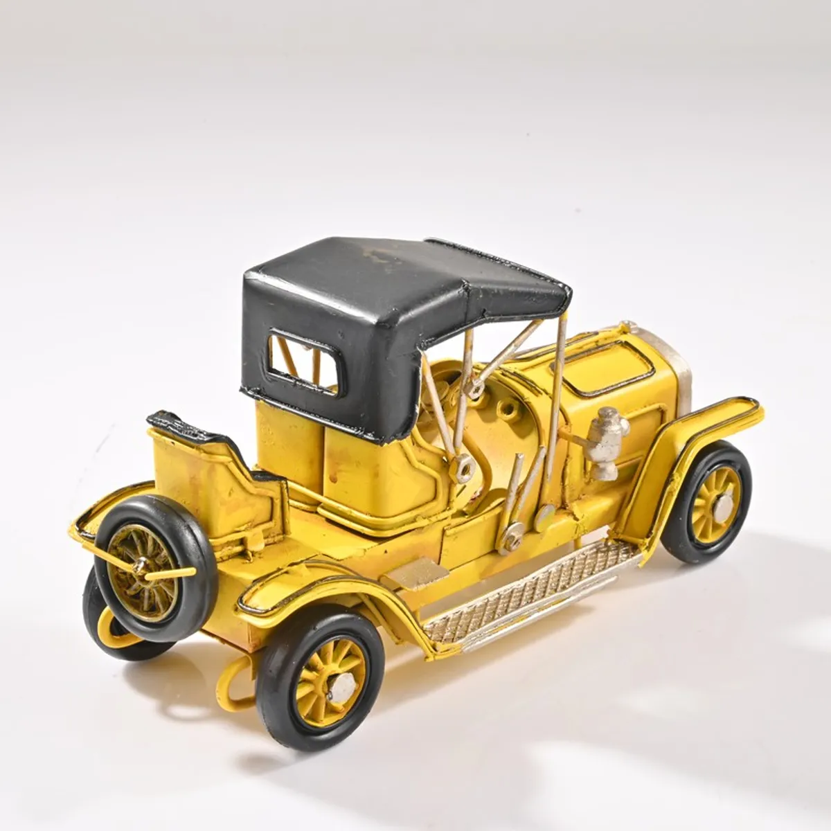 Rear angled view of yellow retro vehicle showpiece