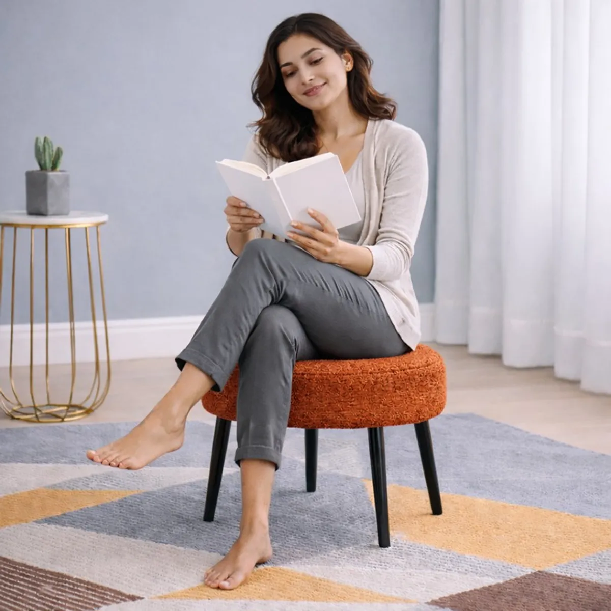 Person seated on a round brown bouclé stool with black legs