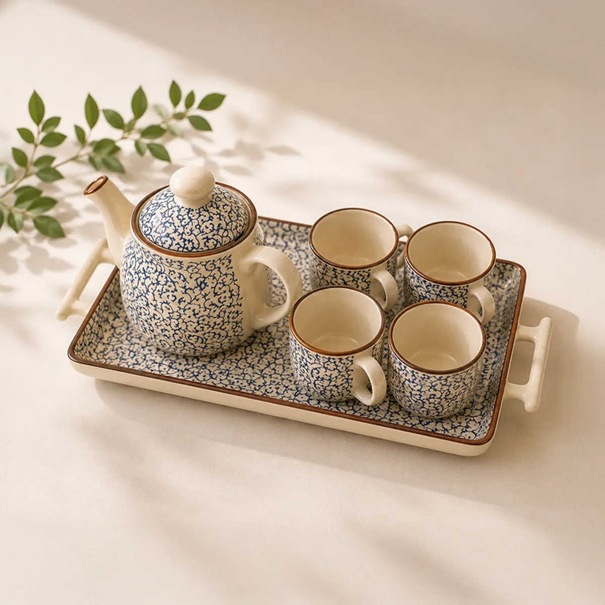 Angled view of a blue-and-white patterned ceramic tea set on a tray