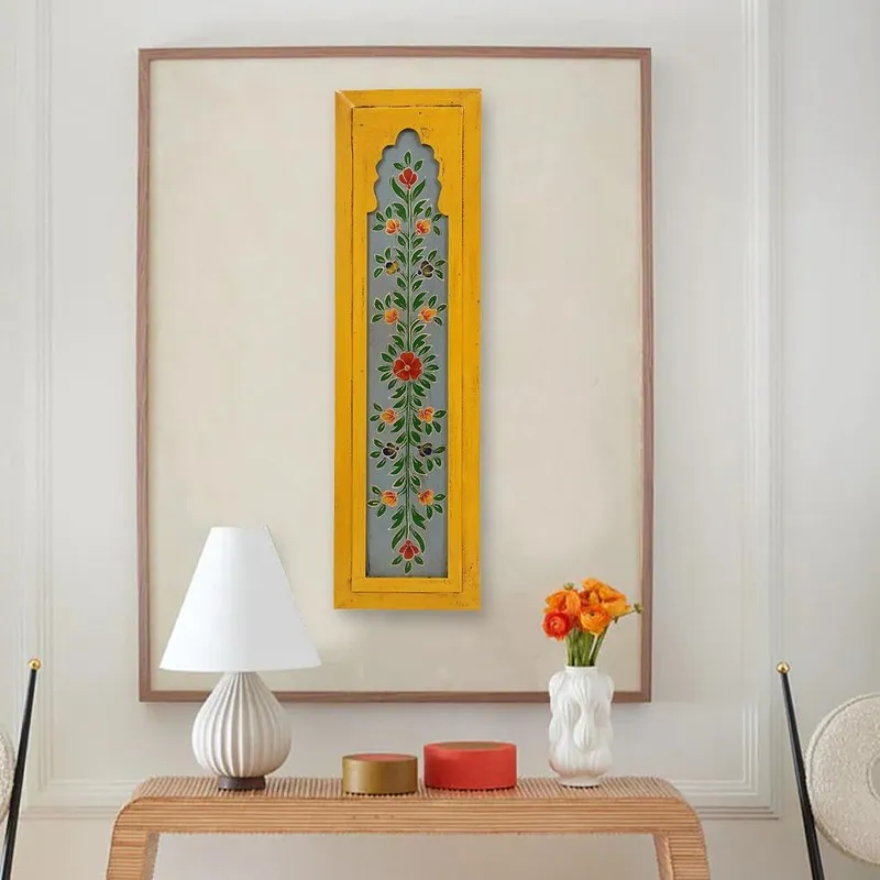 Yellow floral wall accent displayed above a console table