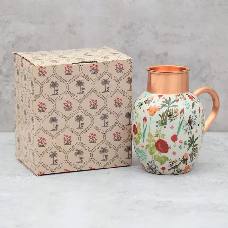Floral copper jug beside its patterned gift box and tumbler