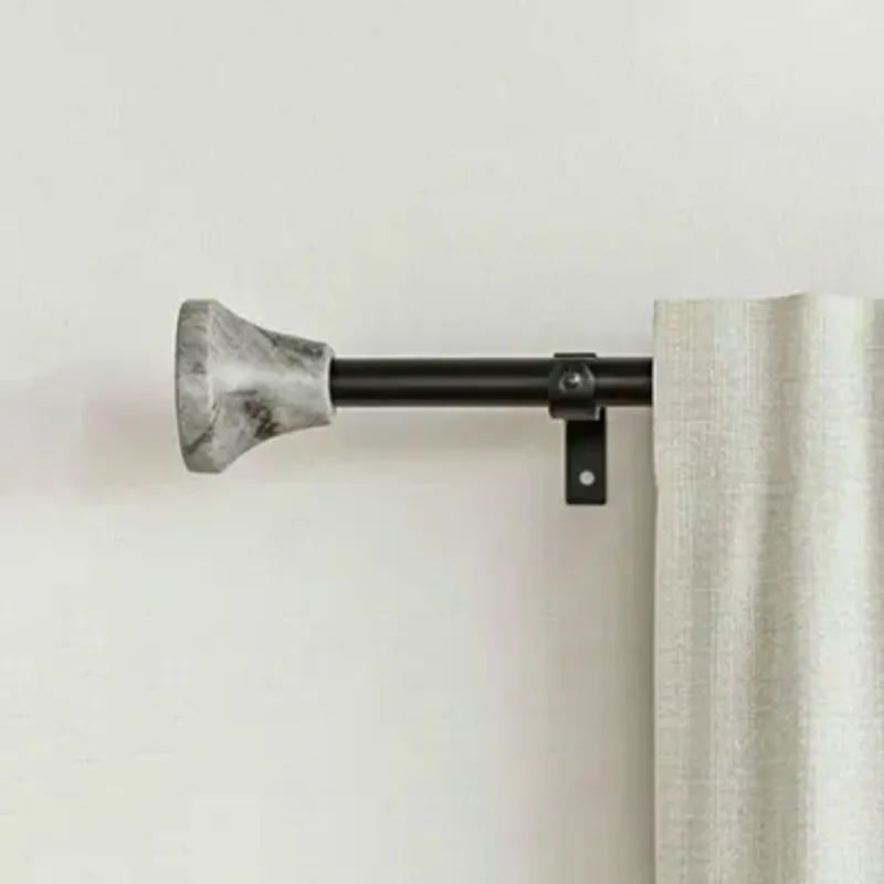 Black curtain rod with grey urn finial and bracket beside a light curtain