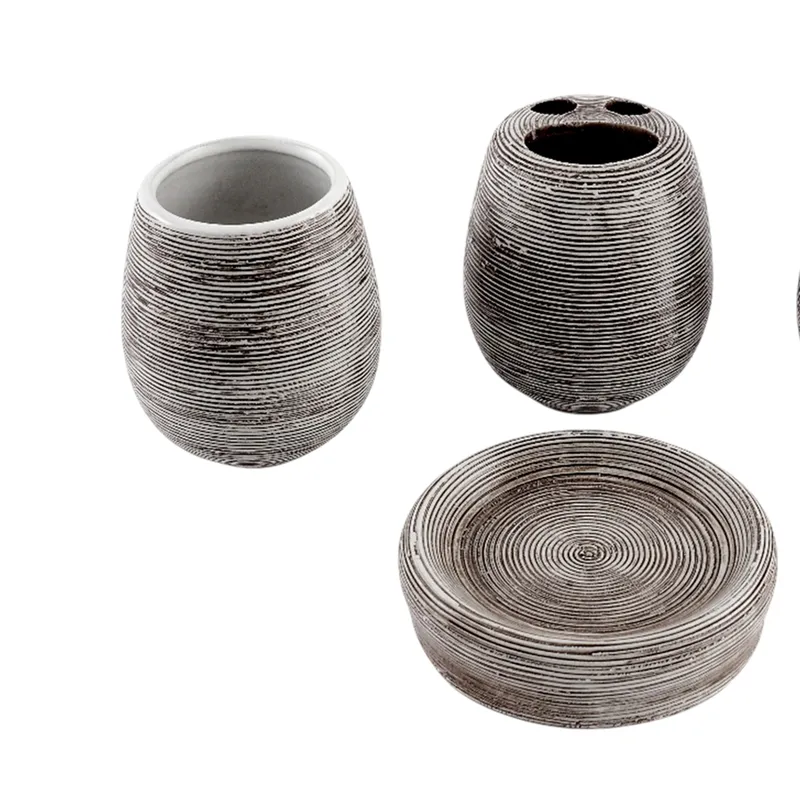 Close view of ribbed ceramic tumbler, toothbrush holder and soap dish