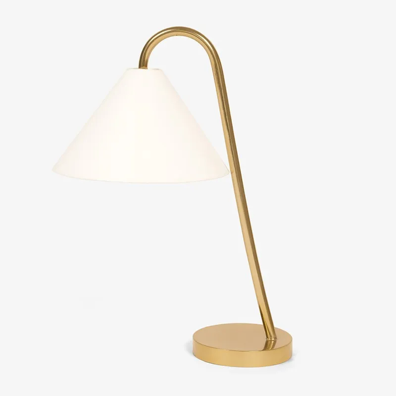 Angled view of white shade and gold swan neck table lamp