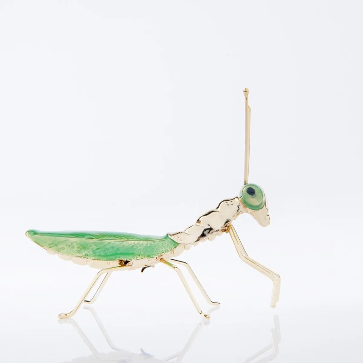 Side view of green enamel and brass praying mantis showpiece