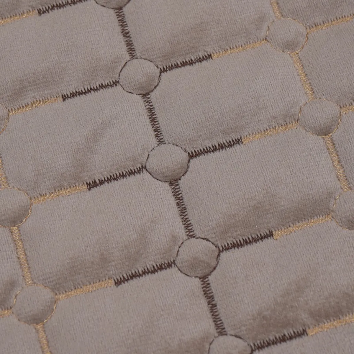 Close-up of the cover's geometric stitched surface in brown