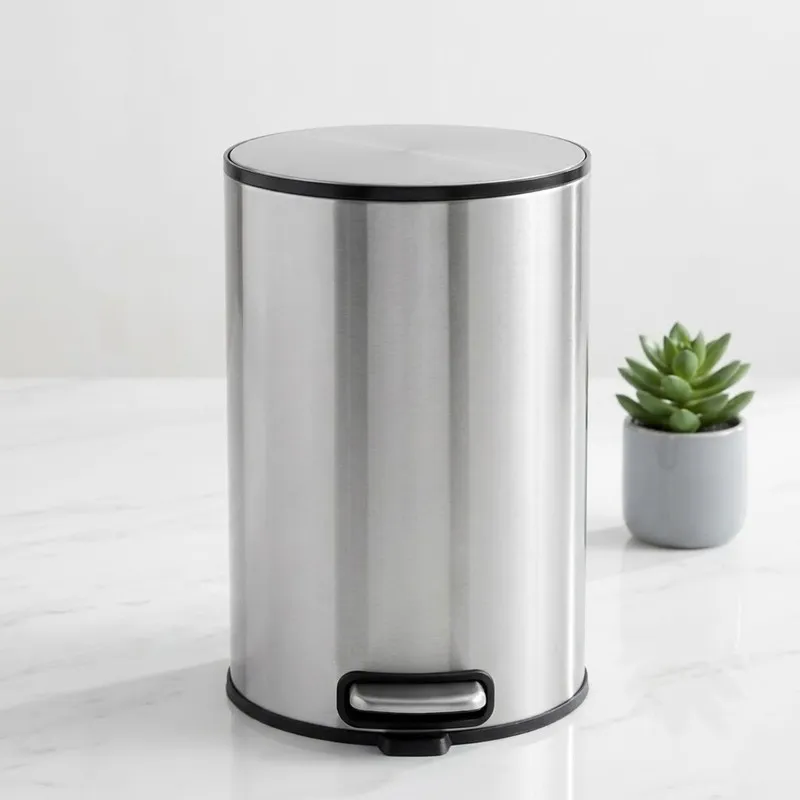 Silver cylindrical metal dustbin with black rim and pedal
