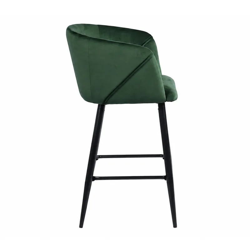 Side view of green velvet bar chair with black metal frame