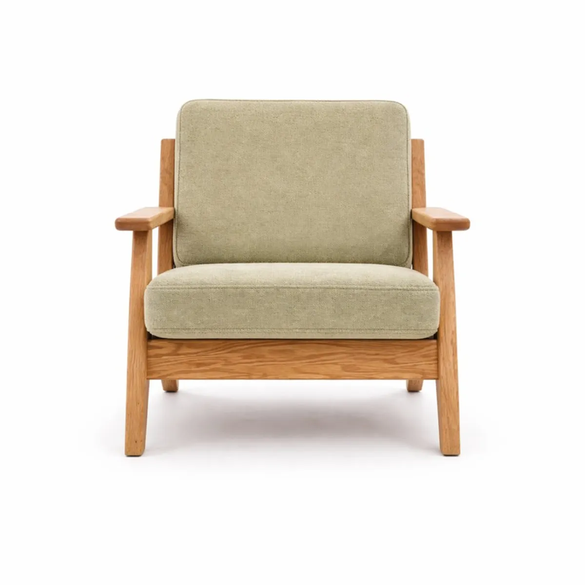 Front view of a green velvet accent chair with teak wood arms and legs