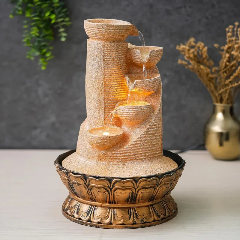 Angled view of ivory LED cascade fountain with tiered bowls and ornate bronze-toned base