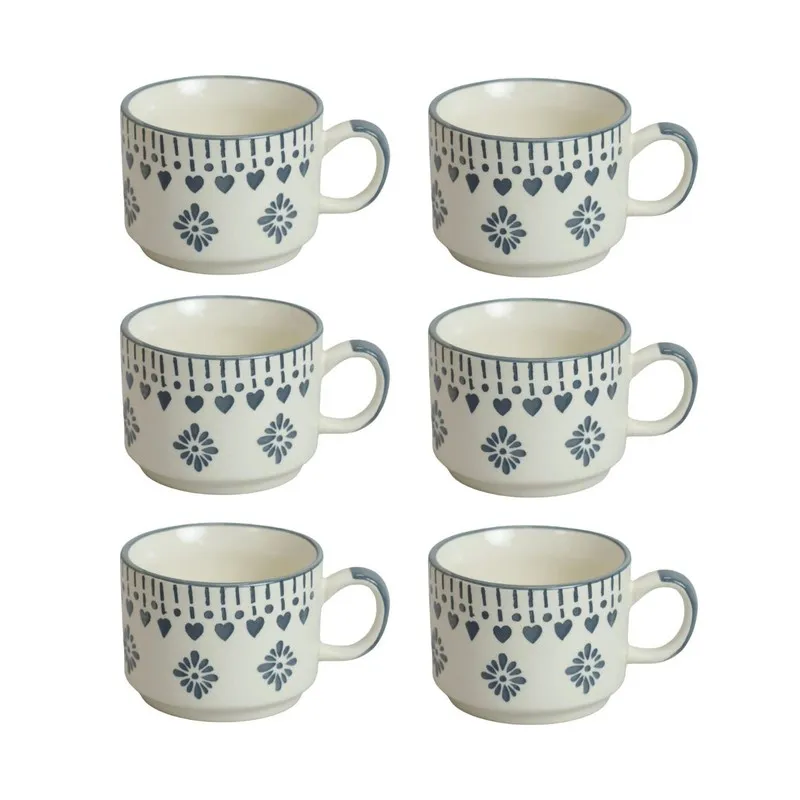 Six matching white ceramic cups shown on a plain background