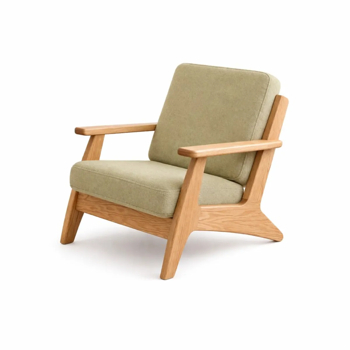 Three-quarter view of a green velvet teak wood accent chair on a white background