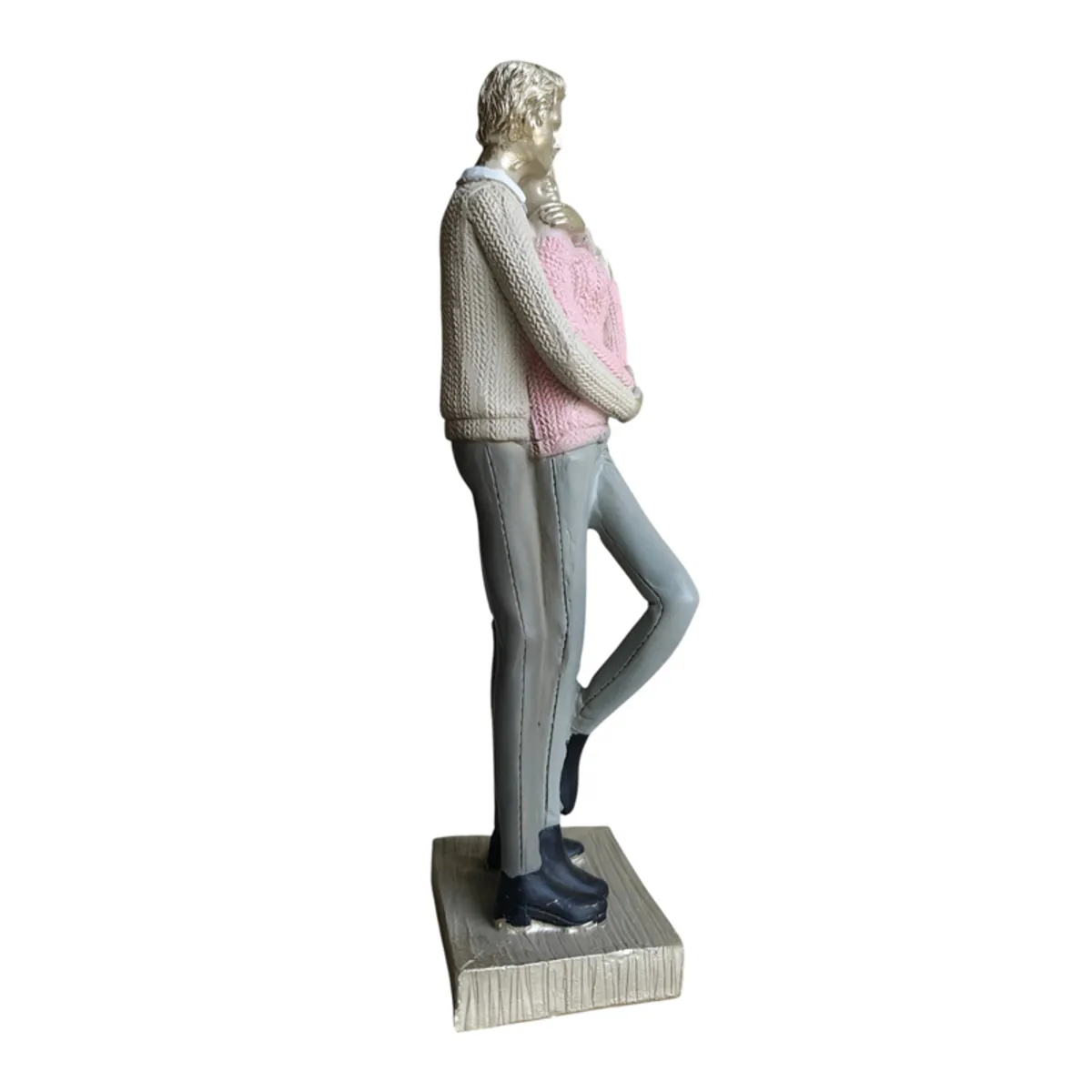 Profile view of pink and grey couple sculpture on its base